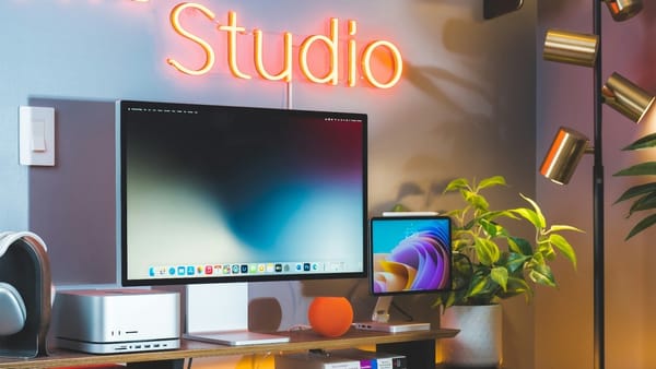 Mac Studio on Desk surrounded by Studio Display, HomePod mini, and more