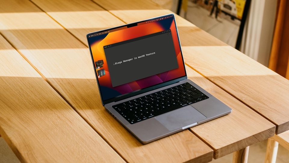 MacBook Pro showing Stage manger feature on top of a wooden table