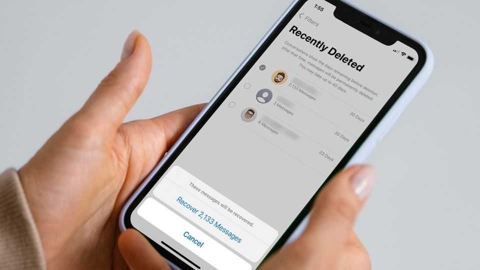 iPhone in hand showing how to recover deleted messages