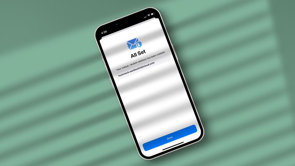 iPhone on green background showing temporary email ID