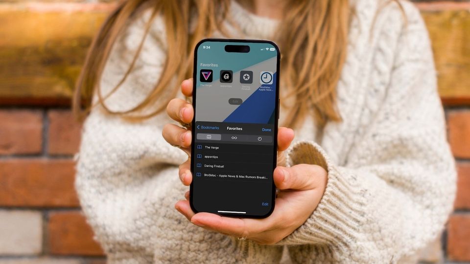 Girl holding iPhone showing Safari Favorites feature
