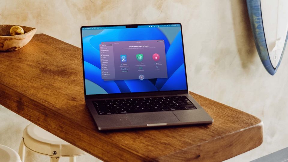 MacBook Pro on wooden slab showing Mac cleanup feature