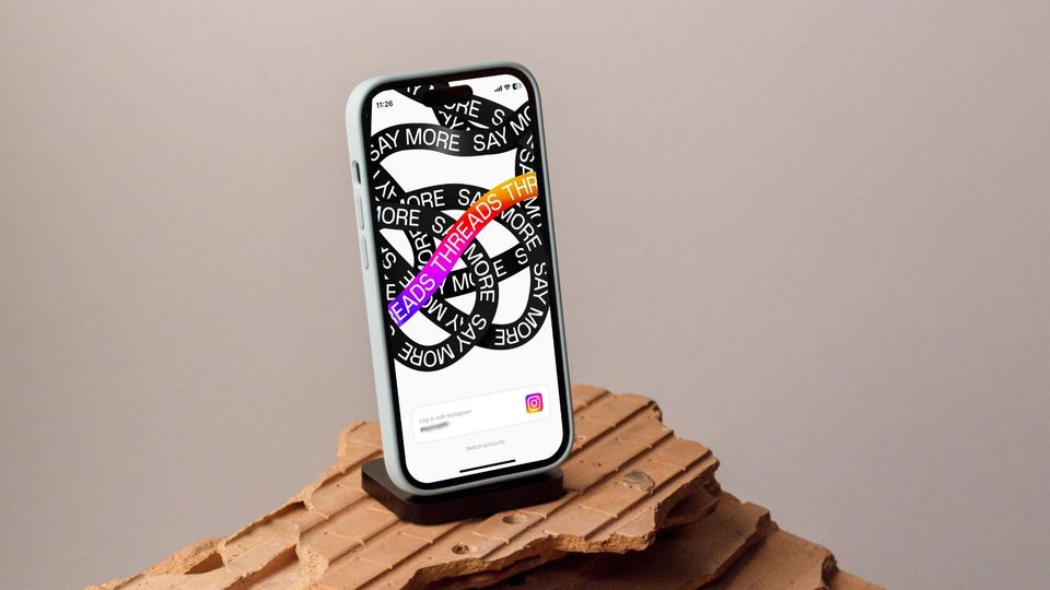 iPhone on stand showing Threads - an Instagram app