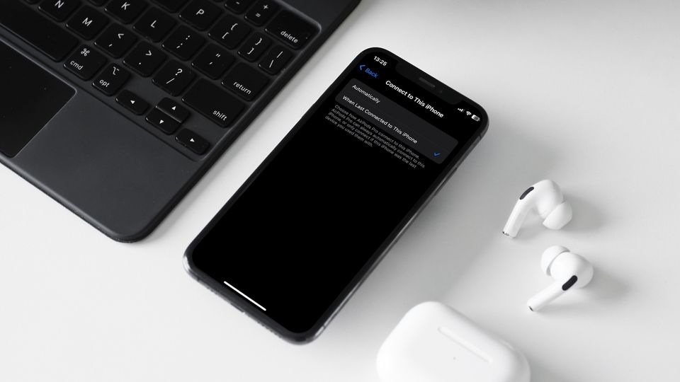 iPhone, AirPods Pro, and Magic Keyboard in fra