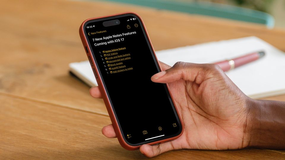 Man holding iPhone with Apple Notes showing iOS 17 features