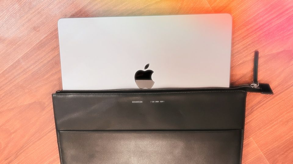 14-inch MacBook Pro half inside a leather folio sleeve