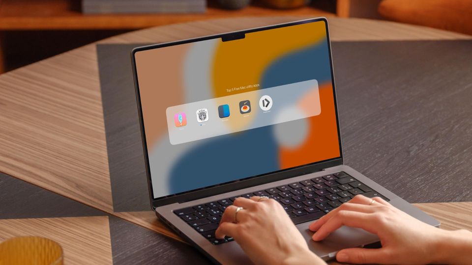 Girl using MacBook pro on table showing free Mac utility apps