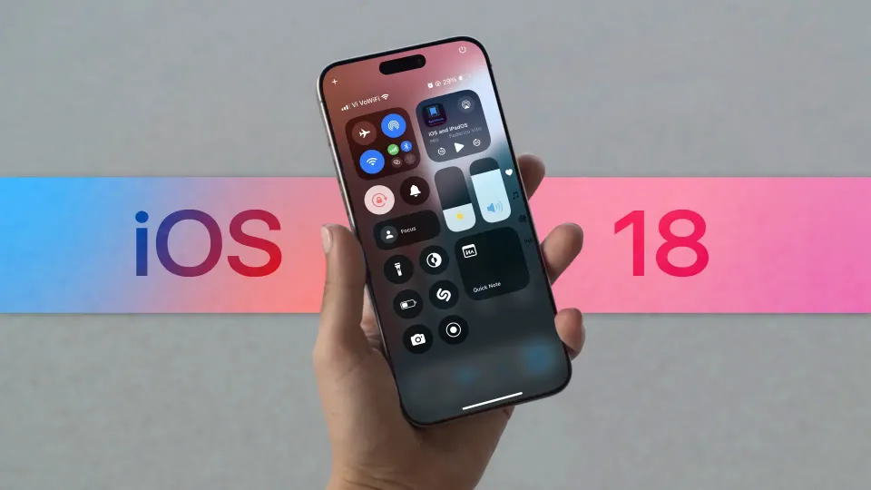 iphone in hand showing iOS 18